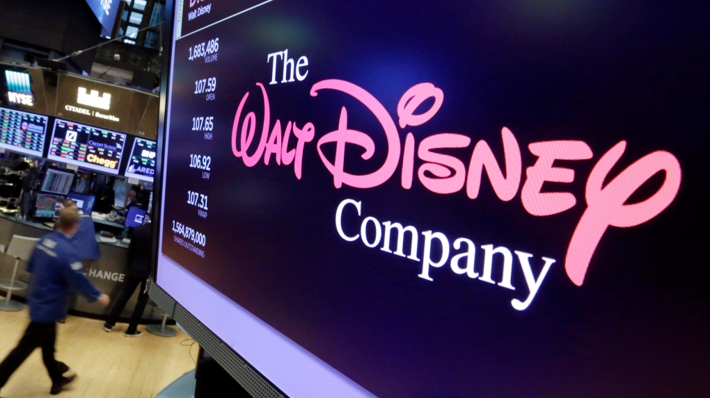 In this Aug. 8, 2017, file photo, The Walt Disney Co. logo appears on a screen above the floor of the New York Stock Exchange.  (AP Photo/Richard Drew, File)