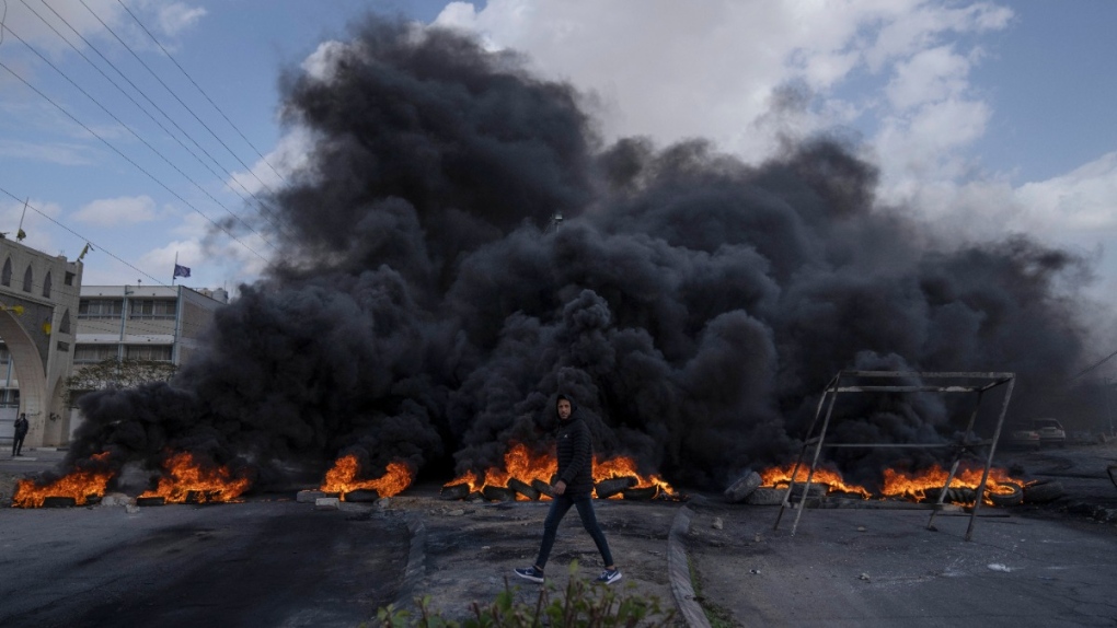 Palestinian protesters block the main road with burning tires in the West Bank city of Jericho, Feb. 6, 2023. (AP Photo/Nasser Nasser)