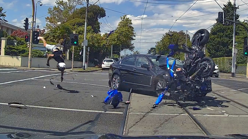 Dash cam captures motorcyclist flipping over hood of car after crash at an Australian intersection