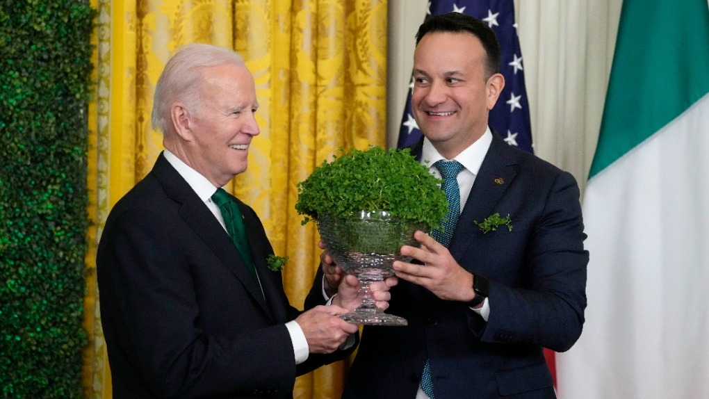 President Joe Biden and Ireland's Taoiseach Leo Varadkar hold a bowl of shamrocks during a St. Patrick's Day reception in the East Room of the White House, Friday, March 17, 2023, in Washington. (AP Photo/Alex Brandon)