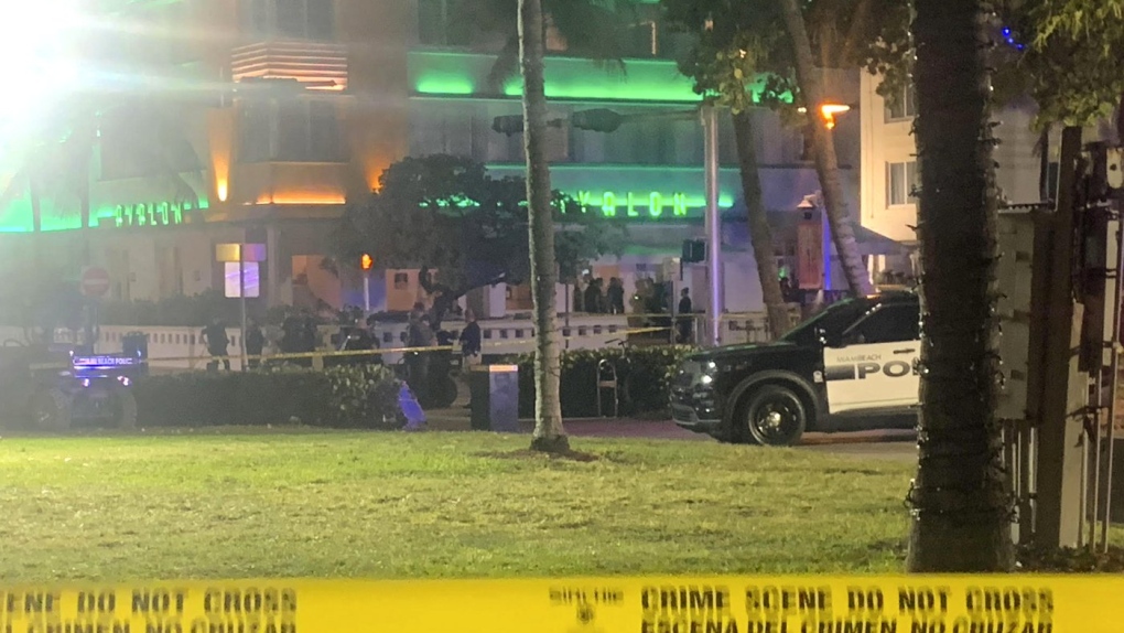 Crime scene tape is shown at the scene along Ocean Drive in Miami Beach, Fla. Friday, March 17, 2023, where police say one person was killed and a second was wounded when gunfire erupted in an area of Miami Beach crowded with people on spring break. (Aaron Leibowitz/Miami Herald via AP)