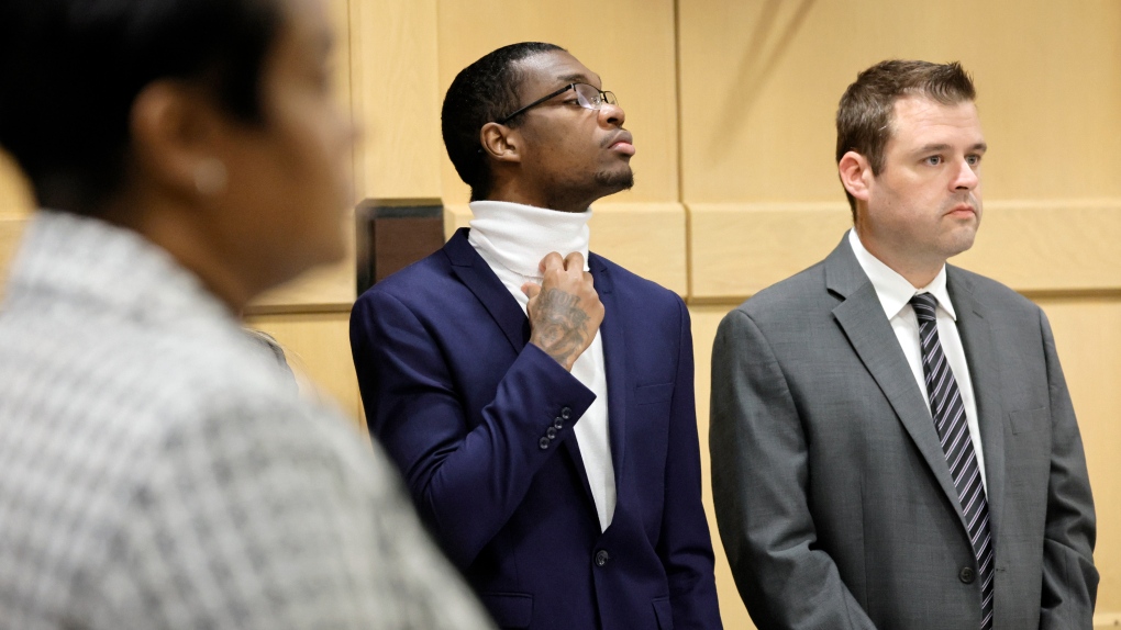 Shooting suspect Michael Boatwright, adjusts his turtleneck as he stands with his attorney Joseph Kimok on day seven of jury deliberations in the XXXTentacion murder trial at the Broward County Courthouse in Fort Lauderdale, Fla., on March 16, 2023. (Amy Beth Bennett/South Florida Sun-Sentinel via AP)