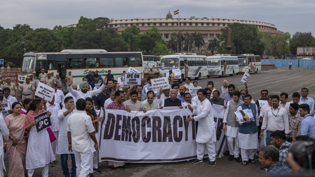 Lawmakers from India's opposition Congress and other parties hold a banne as they march against the Narendra Modi-led government alleging that Indian democracy is in danger, during a protest outside India's parliament in New Delhi, India, Friday, March 24, 2023. (AP Photo/Altaf Qadri)