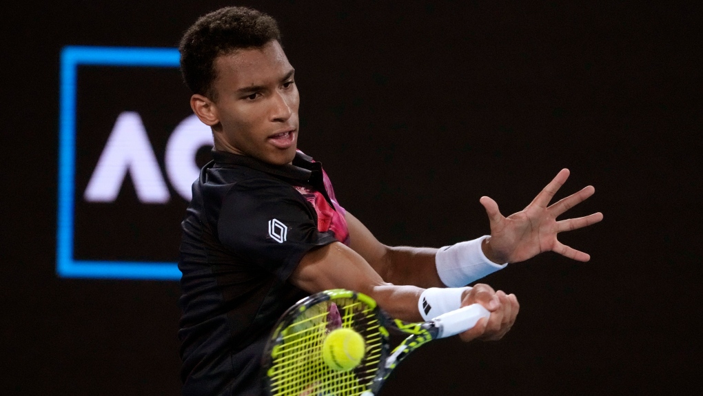 Felix Auger-Aliassime of Canada plays a forehand return to Alex Molcan of Slovakia during their second round match at the Australian Open tennis championship in Melbourne, Australia, Wednesday, Jan. 18, 2023. (AP Photo/Ng Han Guan)