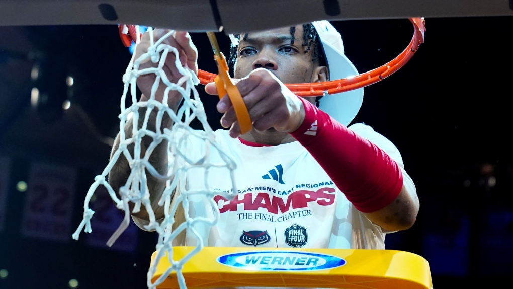 Florida Atlantic's Alijah Martin (15) cuts the net after Florida Atlantic defeated Kansas State in an Elite 8 college basketball game in the NCAA Tournament's East Region final, Saturday, March 25, 2023, in New York. (AP Photo/Frank Franklin II) 