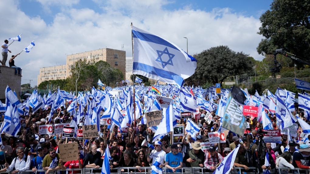 Israelis protest against Prime Minister Benjamin Netanyahu's judicial overhaul plan outside the parliament in Jerusalem, March 27, 2023. (AP Photo/Ohad Zwigenberg)