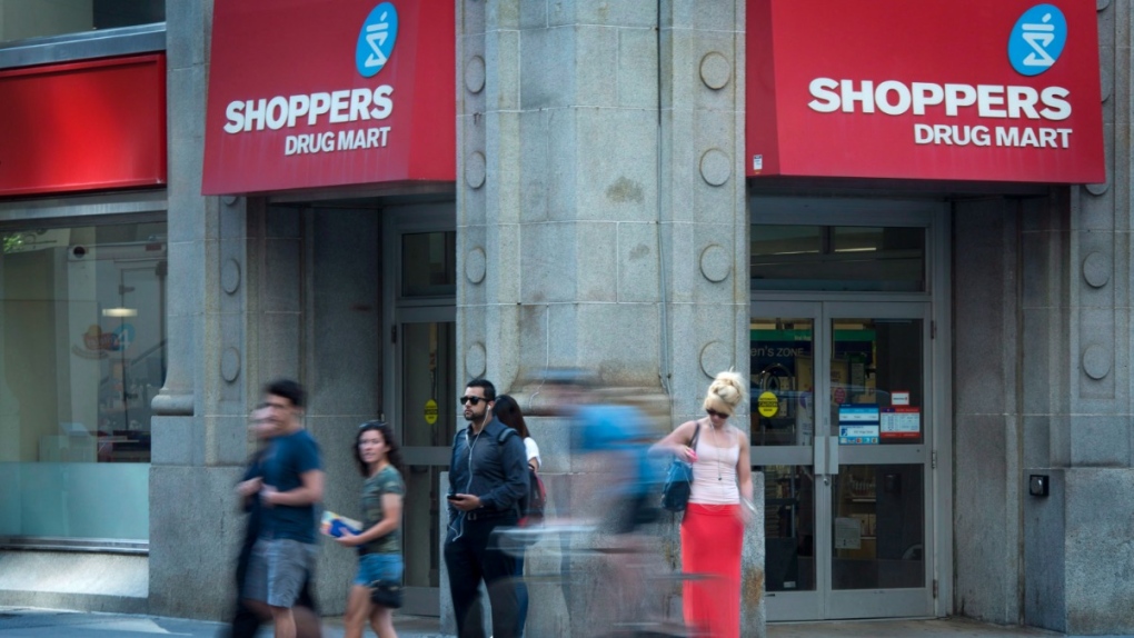 People pass by a Shoppers Drug Mart in downtown Toronto, on July 15, 2013. (Graeme Roy / THE CANADIAN PRESS)