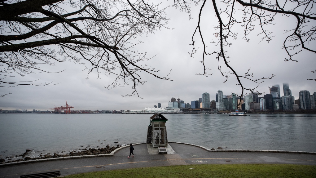 A person walks past the Nine O'Clock Gun on the seawall in Stanley Park, in Vancouver, B.C., Thursday, Feb. 10, 2022. THE CANADIAN PRESS/Darryl Dyck