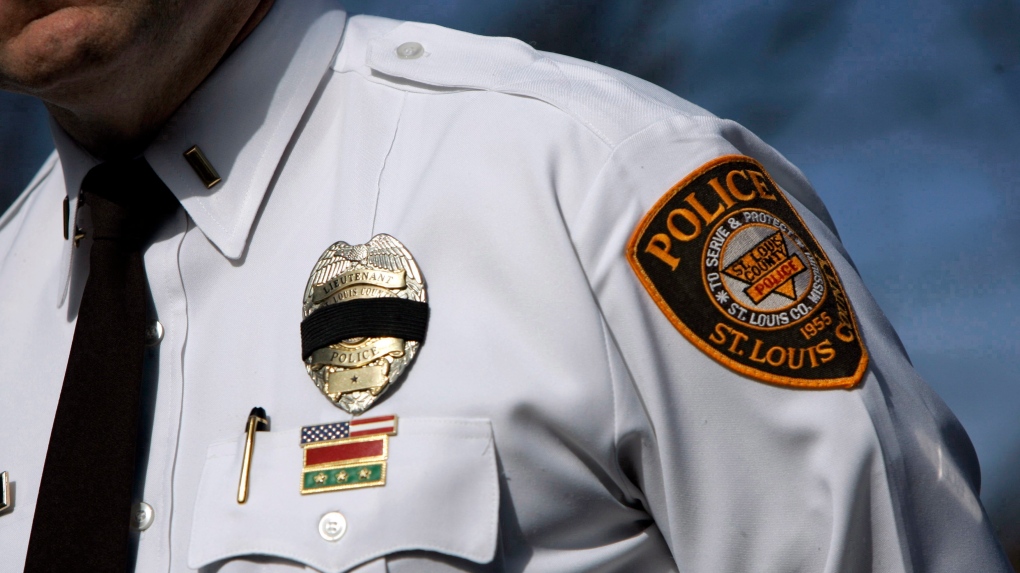 A black band is seen around the badge of St. Louis County Police Lt. Gary Berra during a news conference Friday, Feb. 8, 2008, in Kirkwood, Mo. (AP Photo/Jeff Roberson)
