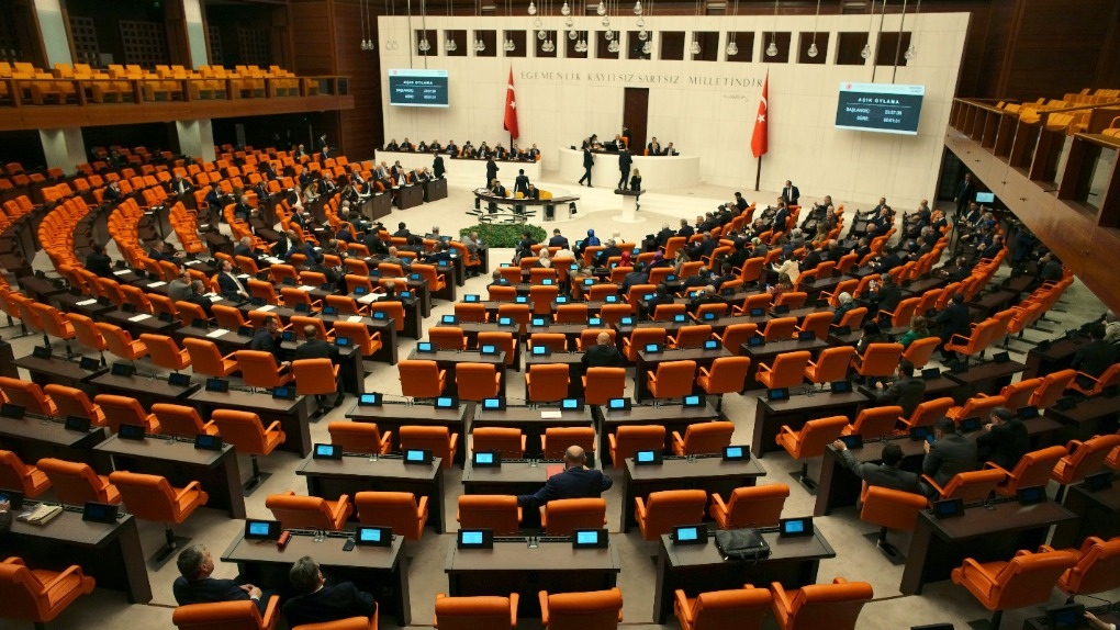 Turkish lawmakers vote in favor of Finland's bid to join NATO, late Thursday, March 30, 2023, at the parliament in Ankara, Turkey. (AP Photo/Burhan Ozbilici)