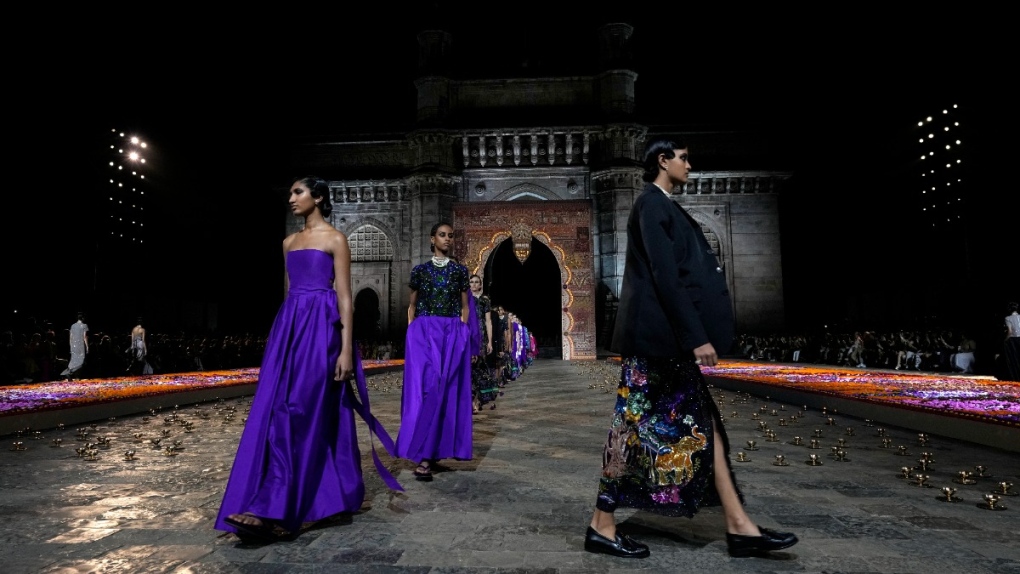 Models display creations for the Dior Pre-Fall 2023 collection at the Gateway of India landmark monument in Mumbai, India, on March 30, 2023. (Rafiq Maqbool / AP) 