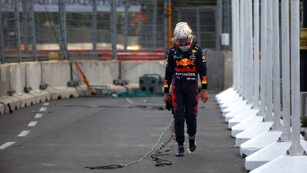 Red Bull driver Max Verstappen walks off the track after crashing out during the Formula One Grand Prix at the Baku Formula One city circuit in Baku, Azerbaijan, on June 6, 2021. (Maxim Shemetov, Pool via AP) 