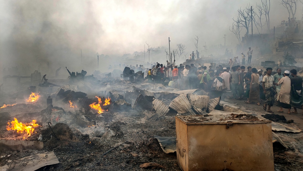 Rohingya refugees try to salvage their belongings after a major fire in their Balukhali camp at Ukhiya in Cox's Bazar district, Bangladesh, Sunday, March 5, 2023.  (AP Photo/Mahmud Hossain Opu)
