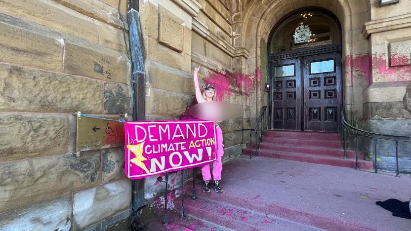 Topless protester who crashed Junos chains herself to Prime Minister’s Office in Ottawa, vandalizes doorway