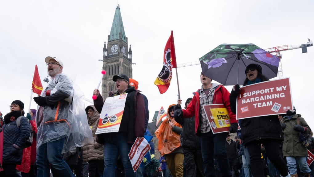 Public Service Alliance of Canada (PSAC) striking government workers walk a picket line around the front lawn of Parliament Hill, in Ottawa, Wednesday, April 26, 2023. THE CANADIAN PRESS/Adrian Wyld
