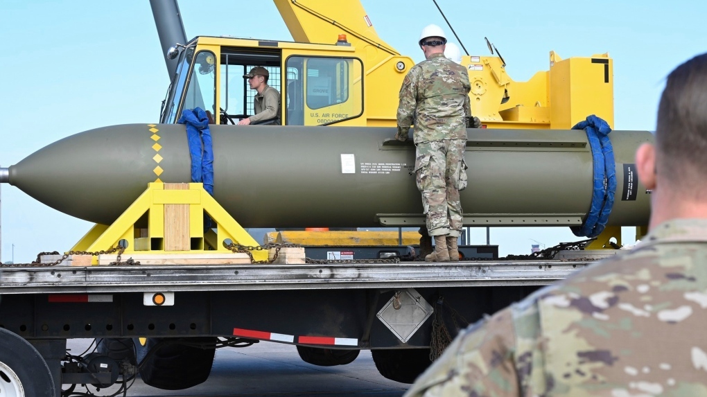 In this photo released by the U.S. Air Force on May 2, 2023, airmen look at a GBU-57, or the Massive Ordnance Penetrator bomb, at Whiteman Air Base in Missouri. That U.S. bomb, designed to destroy underground sites at the height of concerns a decade ago over Iran's nuclear program, has briefly reappeared amid new tensions with the Islamic Republic. (U.S. Air Force via AP)