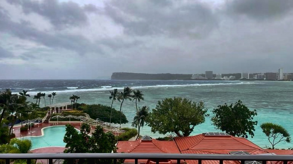 Rain, winds lash Guam as Typhoon Mawar closes in and residents shelter