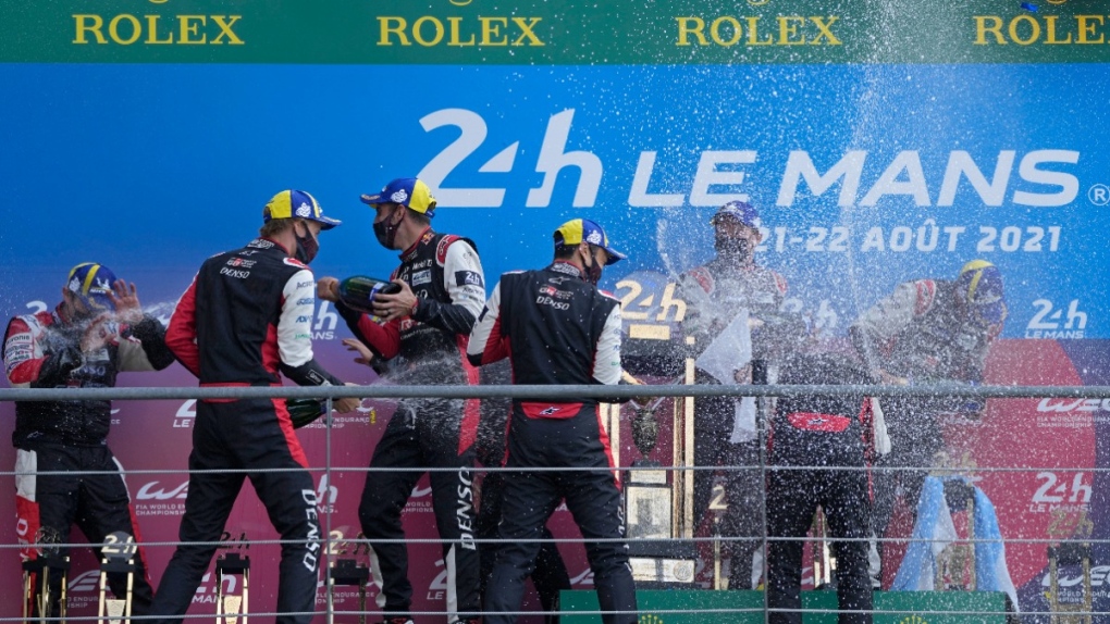 The Toyota Gazoo Racing's winner drivers Mike Conway of Britain, Kamui Kobayashi of Japan and Jose Maria Lopez of Argentina, and the second placed drivers Sebastien Buemi of Switzerland, Kazuki Nakajima of Japan and Brendon Hartley of New Zealand celebrate on the podium of the 24-hour Le Mans endurance race in Le Mans, France, on Aug. 22, 2021. (AP Photo/Francois Mori, File)