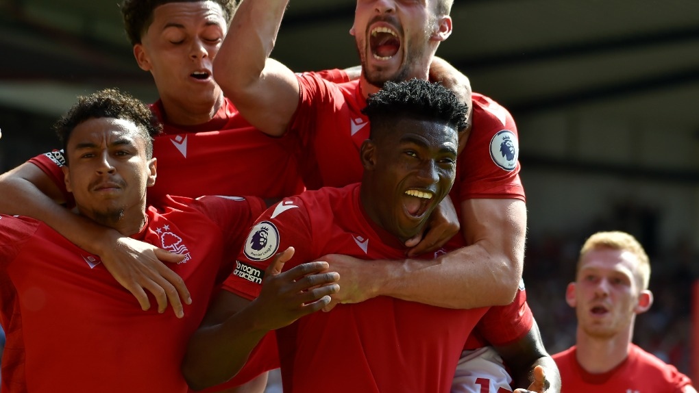Nottingham Forest's Taiwo Awoniyi, center, celebrates with his teammates after scoring against West Ham during the English Premier League soccer match between Nottingham Forest and West Ham United at the City ground in Nottingham, England, Sunday, Aug. 14, 2022. (AP Photo/Rui Vieira)
