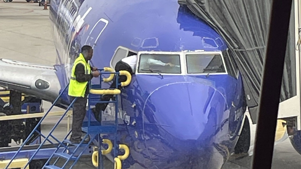 A Southwest pilot had to crawl through an airplane window after a customer accidentally locked the flight deck door, according to the airline. (Courtesy Matt Rexroad / CNN)