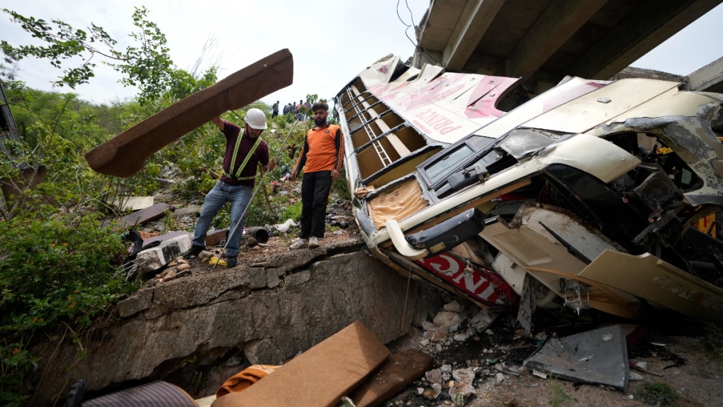 The wreckage of a bus that skidded off a highway bridge into a Himalayan gorge near Jammu, India, on May 30, 2023. (Channi Anand / AP) 