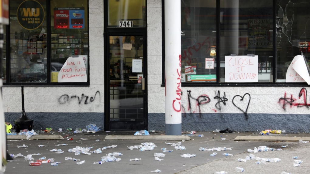 Debris is spread out in front of a convenience store, Tuesday, May 30, 2023, in Columbia, S.C. Richland County deputies said the store owner chased a 14-year-old he thought shoplifted, but didn't steal anything and fatally shot the teen in the back. (AP Photo/Jeffrey Collins)
