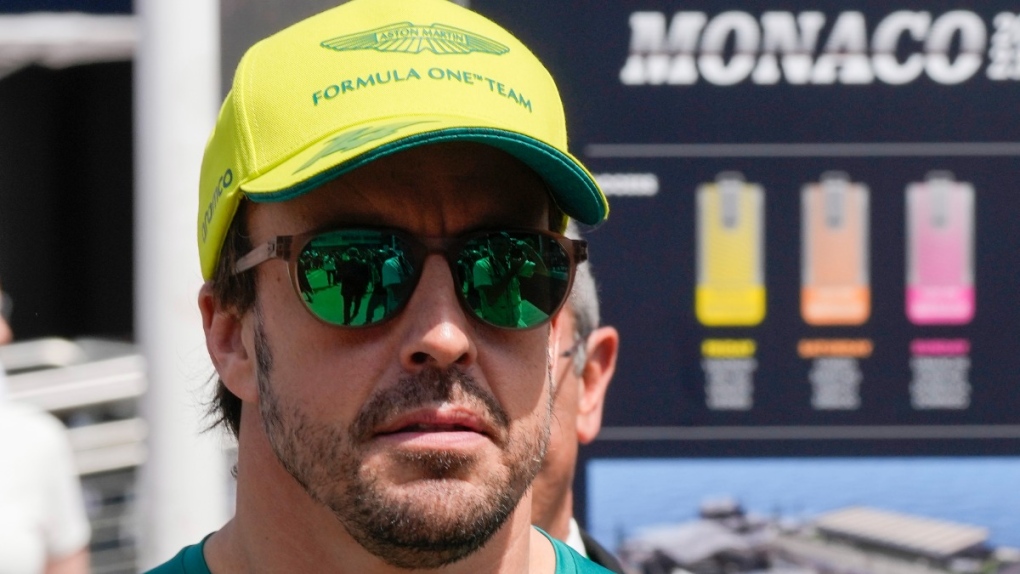 Aston Martin driver Fernando Alonso of Spain walks in the paddock prior to the start of the Monaco Formula One race at the Monaco racetrack, in Monaco, May 28, 2023. (AP Photo/Luca Bruno)