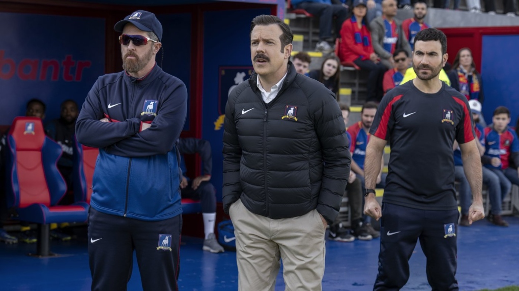 This image released by Apple TV shows Brendan Hunt, from left, Jason Sudeikis and Brett Goldstein in the season three finale episode of "Ted Lasso." (Colin Hutton/Apple TV via AP)
