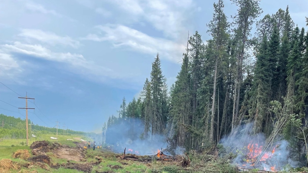 Crews work on a controlled burn near Edson, Alta., in a Tuesday, June 13, 2023.