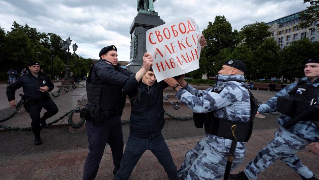 Police officers detain a demonstrator with a poster that reads, "Freedom for Alexei Navalny," in Pushkinskaya Square in Moscow, Russia, June 4, 2023. (AP Photo)