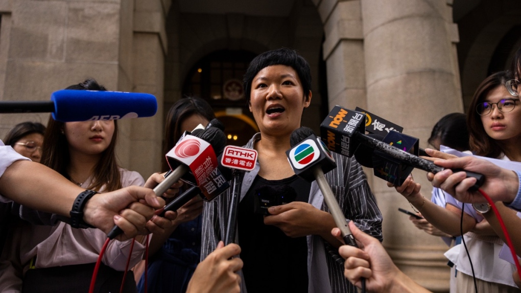 Journalist Bao Choy, centre, speaks to members of the press after being cleared by the top court in Hong Kong, June 5, 2023. (AP Photo/Louise Delmotte)