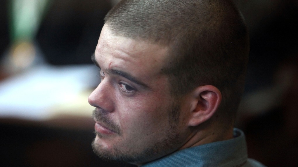 Joran van der Sloot looks back from his seat after entering the courtroom for the continuation of his murder trial at San Pedro prison in Lima, Peru, Jan. 11, 2012. (AP Photo/Karel Navarro, File)