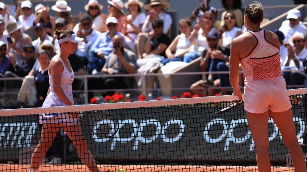 Aryna Sabalenka of Belarus, right, waits on the net as Ukraine's Elina Svitolina, left, walks off the court without shaking hands at the French Open tennis tournament, on June 6, 2023. (Aurelien Morissard / AP) 