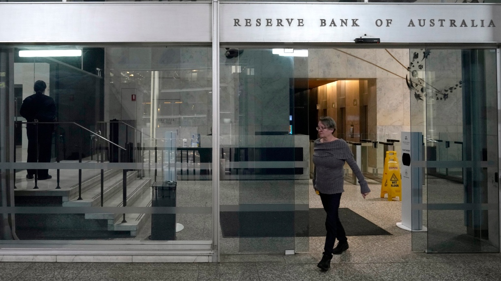 A woman walks out of the Reserve Bank of Australia in Sydney, Tuesday, June 6, 2023. Australia's central bank boosted the cash rate by a quarter of a percentage point to 4.1 percent, following a higher-than-expected 6.8% annual inflation rate for the March quarter. (AP Photo/Rick Rycroft)
