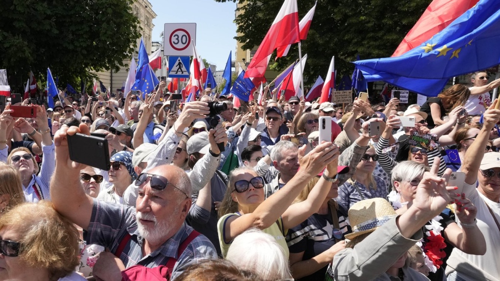Participants join an anti-government march led by the centrist opposition party leader Donald Tusk, who along with other critics accuses the government of eroding democracy, in Warsaw, Poland, Sunday, June 4, 2023. Poland's largest opposition party led a march Sunday meant to mobilize voters against the right-wing government, which it accuses of eroding democracy and following Hungary and Turkey down the path to autocracy. The march is being held on the 34th anniversary of the first partly free elections, a democratic breakthrough in the toppling of communism across Eastern Europe. (AP Photo/Czarek Sokolowski)