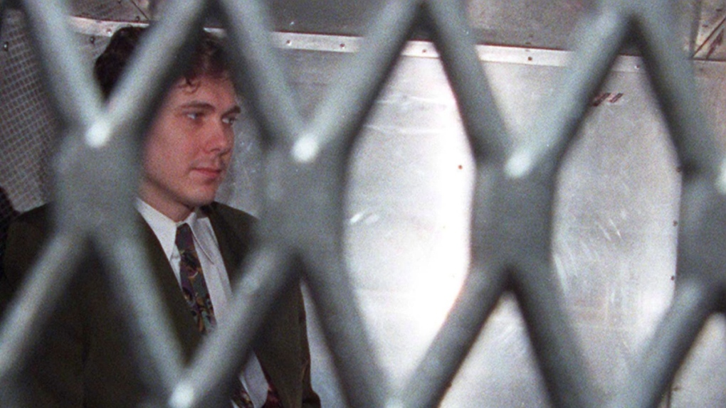 Paul Bernardo arrives at the provincial courthouse in the back of a police van in Toronto in a Nov. 3, 1995, file photo. THE CANADIAN PRESS/Frank Gunn
