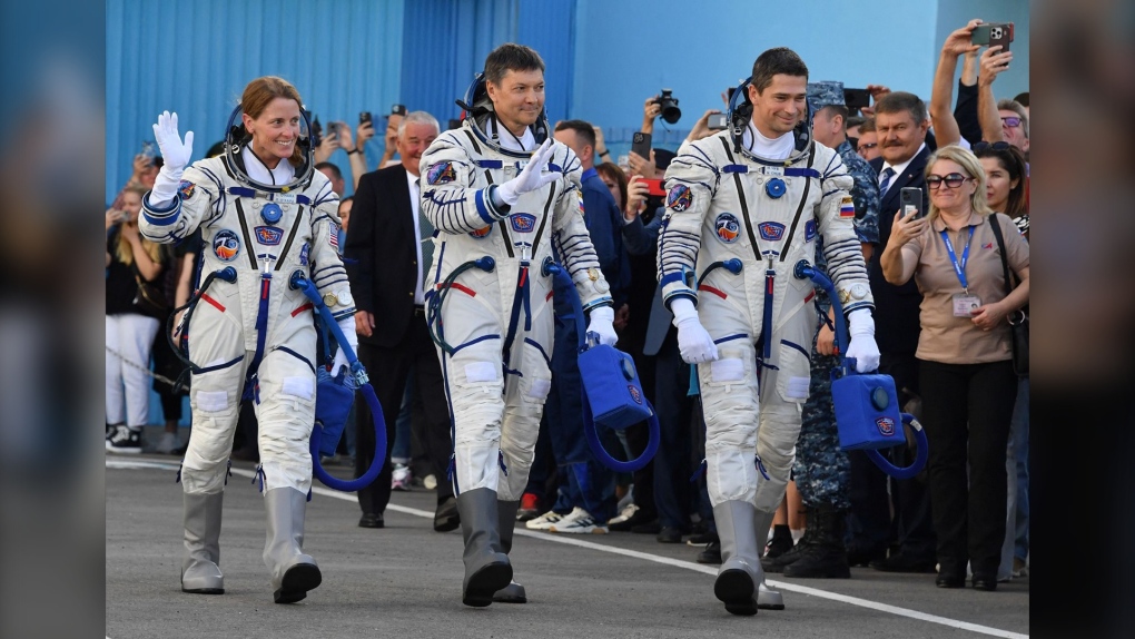 NASA astronaut Loral O'Hara, far left, and Russian Roscosmos cosmonauts Oleg Kononenko and Nikolai Chub, members of the International Space Station (ISS) Expedition 70-71 main crew, walk to report to the head of the Russian space agency Roscosmos during the pre-launch preparations in the Russian leased Baikonur cosmodrome in Kazakhstan on September 15. (Vyacheslav Oseledko/Pool/AFP/Getty Images)