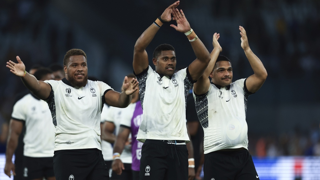 Fiji's players celebrate after the Rugby World Cup Pool C match between Australia and Fiji at the Stade Geoffroy Guichard in Saint-Etienne, France, Sunday, Sept. 17, 2023. (AP Photo/Aurelien Morissard)