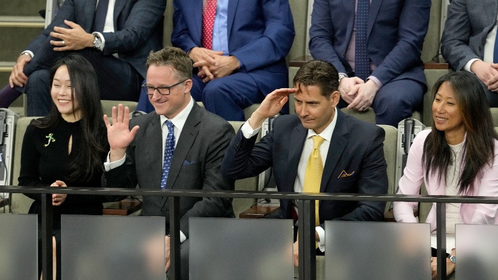 Michael Spavor, centre left, and Michael Kovrig, centre left, receive a standing ovation in the House of Commons prior to U.S. President Joe Biden's address of Parliament, in Ottawa, Friday, March 24, 2023. THE CANADIAN PRESS/Adrian Wyld