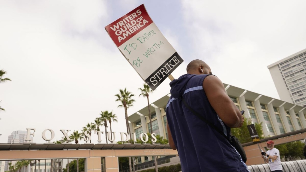 Picketers carry signs outside Fox studios on August 14 in Los Angeles. Writers and heads of the four major studios are set to meet for a second consecutive day on September 21. (Chris Pizzello/Invision/AP)