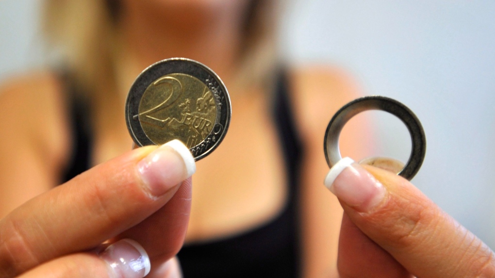 Police display moulds of counterfeit two-euro coins, in the northern Greek city of Thessaloniki, on Thursday, June 28, 2012. The number of fake two-euro coins in circulation has seen a massive increase this year, according to law enforcement agencies. (AP Photo/Nikolas Giakoumidis)