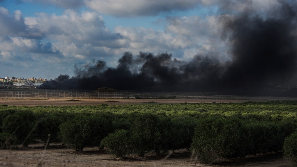 Smoke rises from tires set ablaze by Palestinian demonstrators during a protest along the frontier between Gaza and Israel, as seen from the Israeli side of the fence, Sept. 23, 2023. (AP Photo/Tsafrir Abayov)