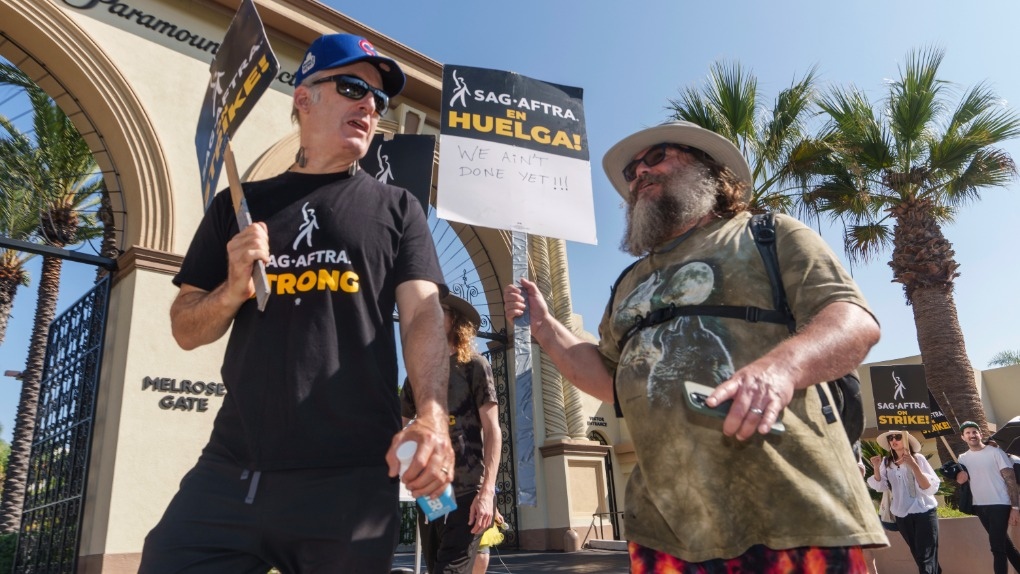 Actors Bob Odenkirk, left, and Jack Black join demonstrators outside the Paramount Pictures Studio in Los Angeles, Tuesday, Sept. 26, 2023. (AP Photo/Damian Dovarganes)
