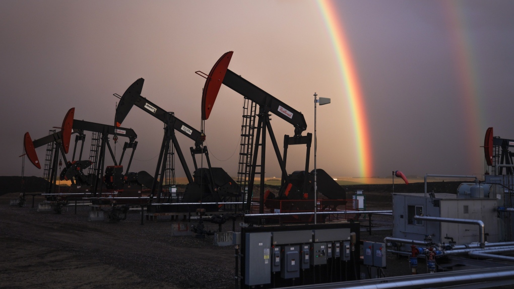 A rainbow appears to come down on pumpjacks drawing out oil and gas from wells near Calgary, Alta., Monday, Sept. 18, 2023. (THE CANADIAN PRESS/Jeff McIntosh)