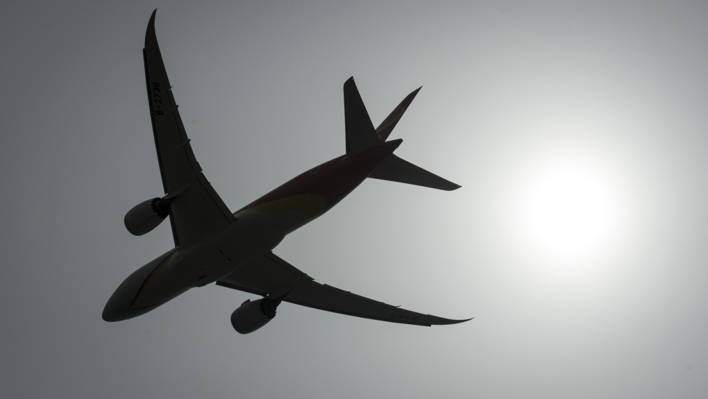 A plane is silhouetted as it takes off from Vancouver International Airport in Richmond, B.C., Monday, May 13, 2019. (THE CANADIAN PRESS/Jonathan Hayward)
