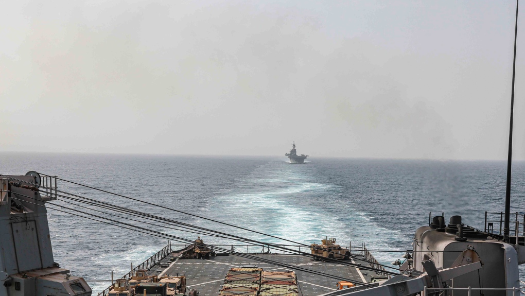 In this image provided by the U.S. Navy, the amphibious dock landing ship USS Carter Hall and amphibious assault ship USS Bataan transit the Bab al-Mandeb strait on Aug. 9, 2023. The top commander of U.S. naval forces in the Middle East says Yemen’s Houthi rebels are showing no signs of ending their “reckless” attacks on commercial ships in the Red Sea. But Vice Adm. (Mass Communications Spc. 2nd Class Moises Sandoval/U.S. Navy via AP)