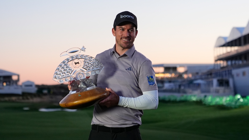 Nick Taylor, of Canada, poses with the trophy after winning the Phoenix Open golf tournament Sunday, Feb. 11, 2024, in Scottsdale, Ariz. (AP Photo/Ross D. Franklin)