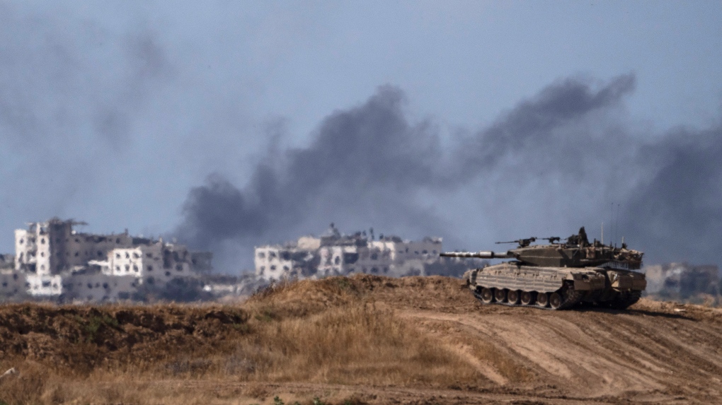 Backdropped by smoke rising to the sky after an explosion in the Gaza Strip an Israeli tank stands near the Israel-Gaza border as seen from southern Israel Monday May 13 2024 AP PhotoLeo Correa