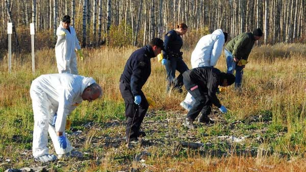 Members of the RCMP Explosive Disposal Unit, RCMP National Post Blast Team, Dawson Creek Detachment and local Search and Rescue conduct a grid search at the site of the second explosion at a gas pipeline, near Dawson Creek, B.C. on Friday Oct. 17, 2008. (THE CANADIAN PRESS / RCMP)