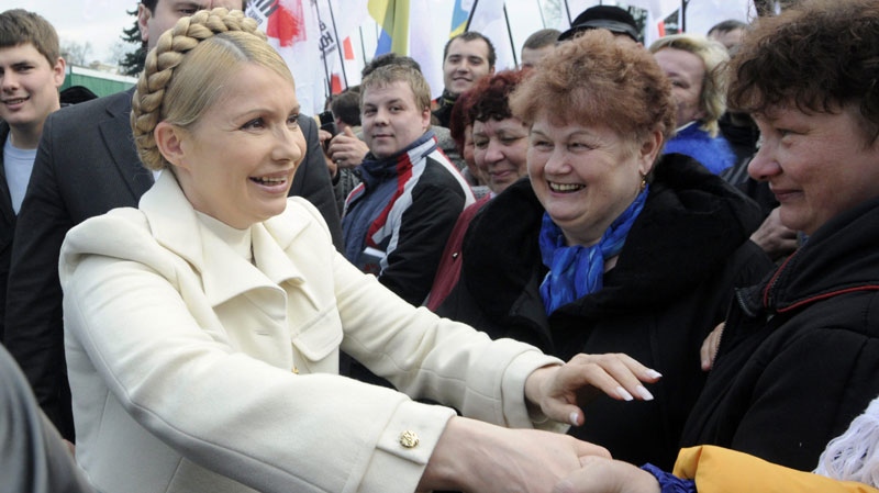 Supporters of former Ukrainian Prime Minister Yulia Tymoshenko greet her supporters during a rally in Kiev, Ukraine, Saturday, April 24, 2010. (AP Photo/Sergei Chuzavkov)